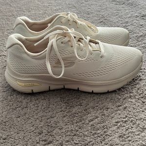 Cream colored skecher arch fit sneaker
